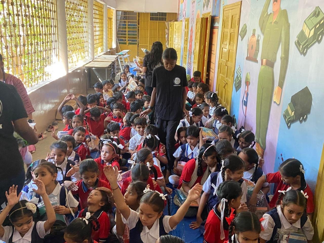Children receiving school kits in a government primary school