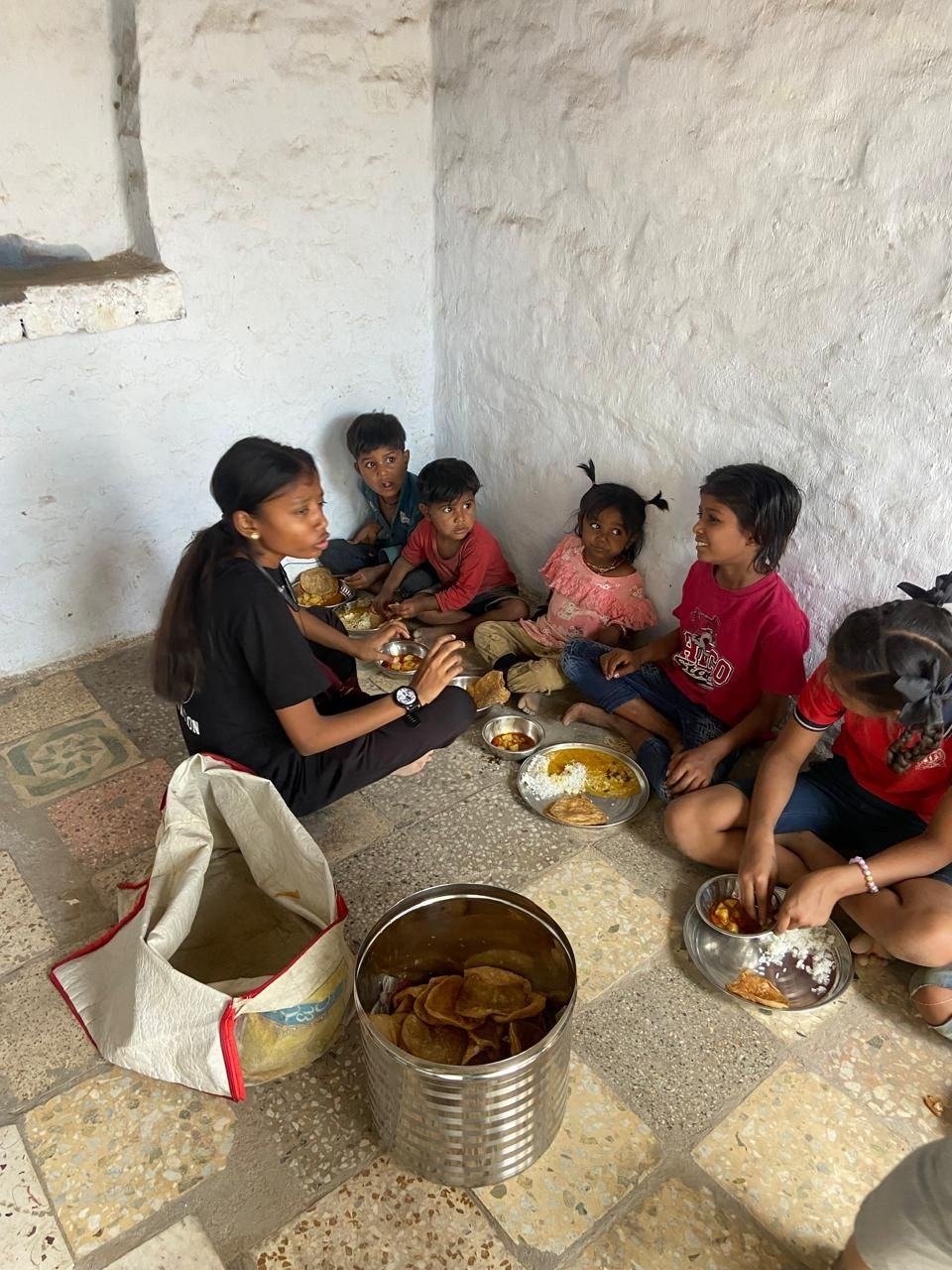 A volunteer serving food outside a shelter